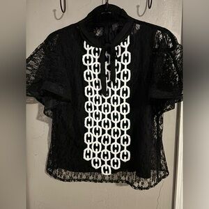 Gracia blouse. Lace outer with solid liner. Bow on front with ruffle collar.